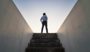 A picture of someone climbing stairs to the future