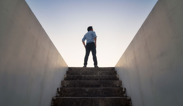 A picture of someone climbing stairs to the future