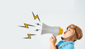 A picture of a child shouting down a megaphone