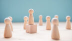 A photo of a pawn on a wooden block (leadership concept)