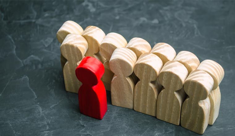 A picture of wooden figures with a chosen red figure