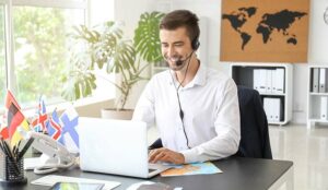 A photo of a call centre agent working at a travel agents