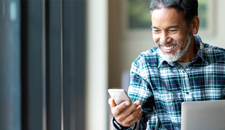 A picture of a happy customer holding a mobile phone