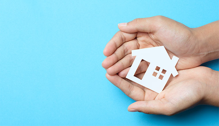 A photo of hands around a house