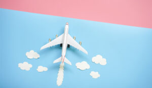 A picture of a passenger plane with clouds