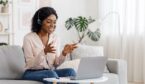 A picture of an agent working at home with a headset and laptop