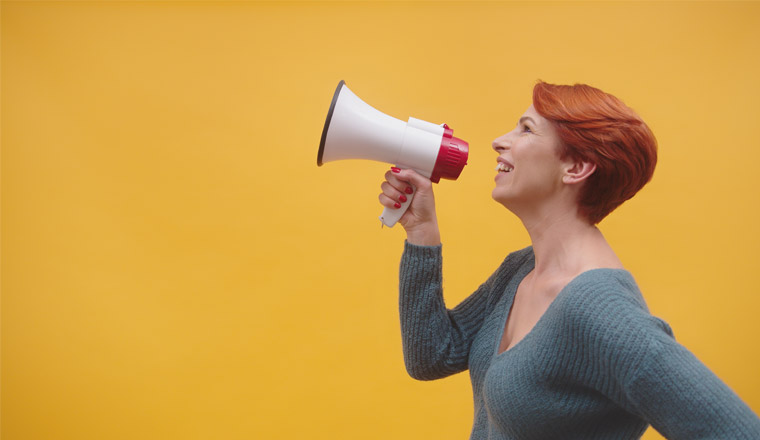 A picture of a lady holding a megaphone