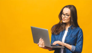 A picture of a lady holding a laptop