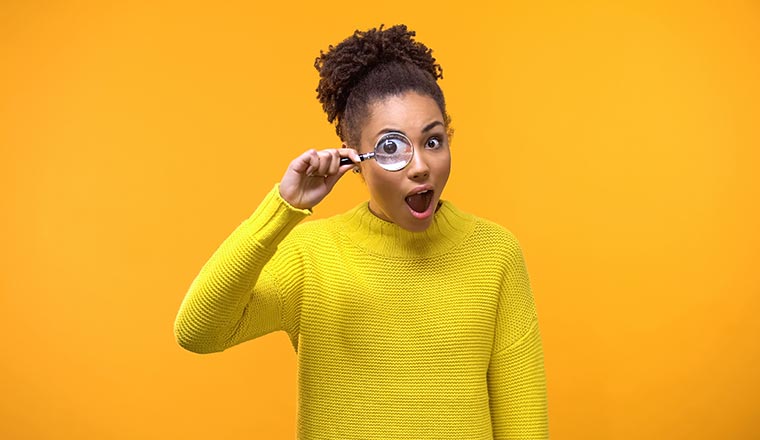 A photo of someone with a magnifying glass in front of their eye