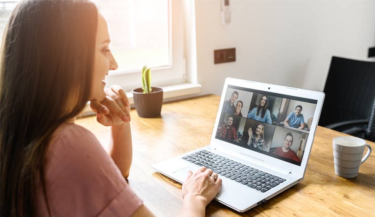 A picture of an agent on a video call with colleagues