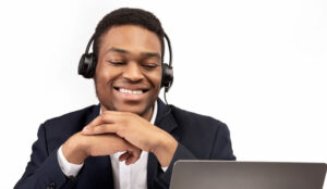 A picture of a happy agent speaking with a headset