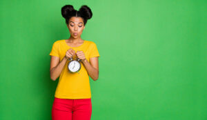 A photo of someone posing with a clock