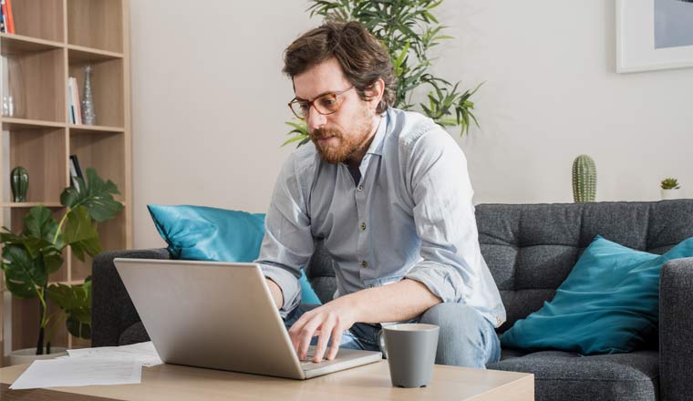 A picture of an agent working at home with laptop