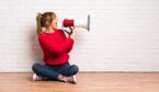 A picture of a lady shouting through a megaphone