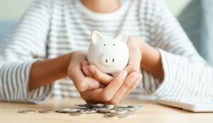 A picture of a person holding a piggy bank