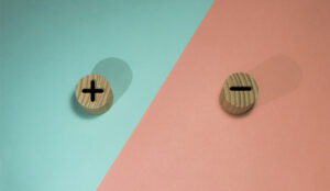 A picture of a plus and minus on wooden buttons