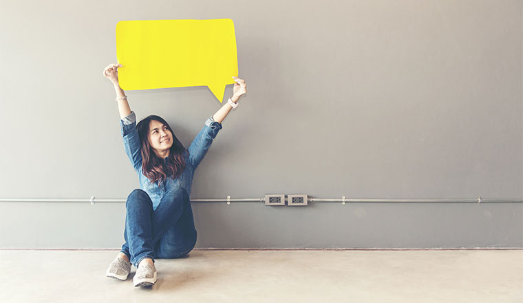 A photo of someone holding a speech bubble