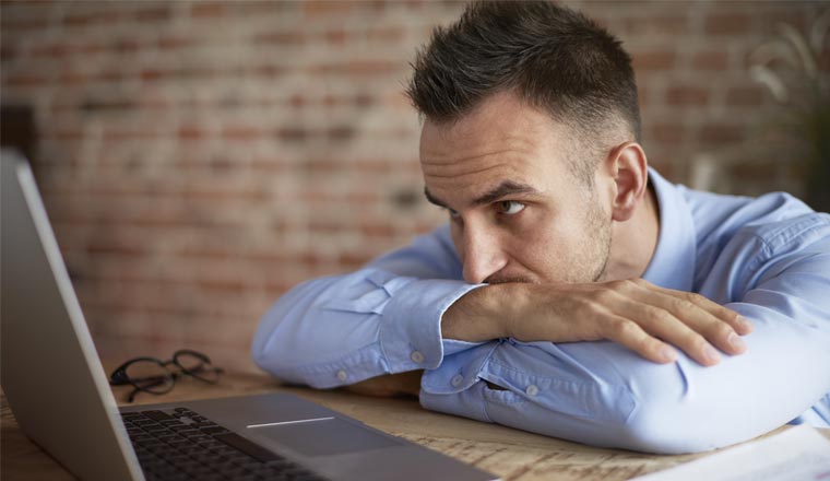 A picture of an agent staring at laptop screen