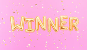 A picture of Winner sign letters with golden confetti.