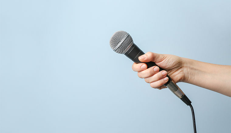 A photo of someone handing out a microphone