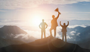 A photo of a team celebrating on a mountain top