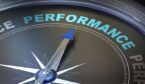 A picture of a compass pointing towards the word "performance"