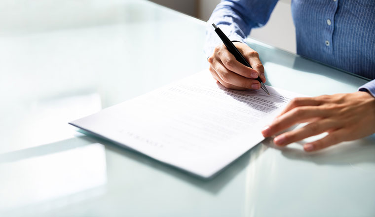 A photo of someone signing a contract