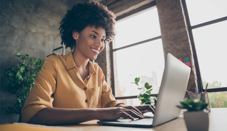 A picture of a woman working at home on laptop