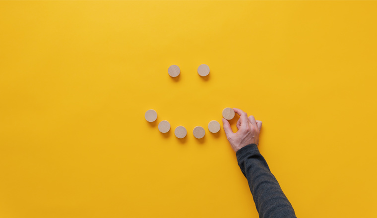 A picture of a smiley face made out of wooden blocks