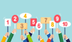 A picture of people holding paddles with scores on them