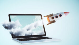 A picture of a rocket launching out of a laptop