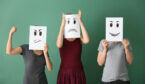 A picture of people hiding behind sheets of paper with faces on
