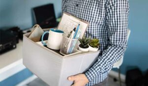 A picture of an employee with a box of belongings