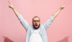 A picture of a happy man holding his arms in the air