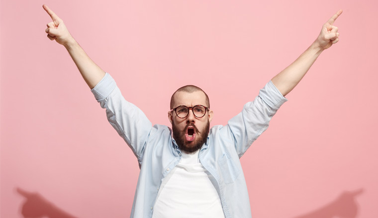 A picture of a happy man holding his arms in the air