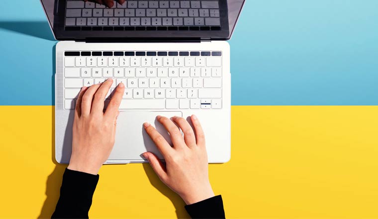 A picture of a laptop from above on a blue and yellow background