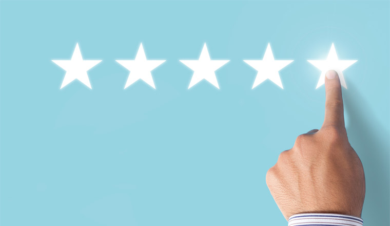 Hand choosing 5 stars rating on blue background