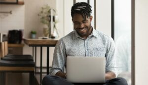 A picture of an agent working at home on a laptop