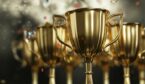 A close up golden trophy award with falling confetti