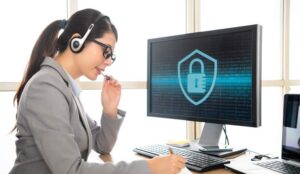 A picture of a person in a headset sat in front of a screen showing a padlock