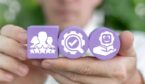 A picture of a person holding one purple cube with a rating icon, and two purple cylinders with other CX icons