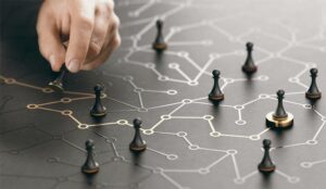 Image showing pawns on a network map with a path leading to one on a gold stand