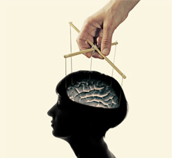 An image of a head with puppet strings attached to the brain