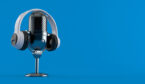 Radio microphone with headphones on blue background