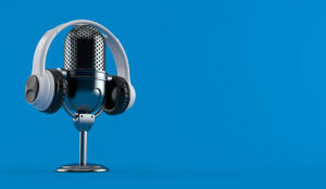 Radio microphone with headphones on blue background