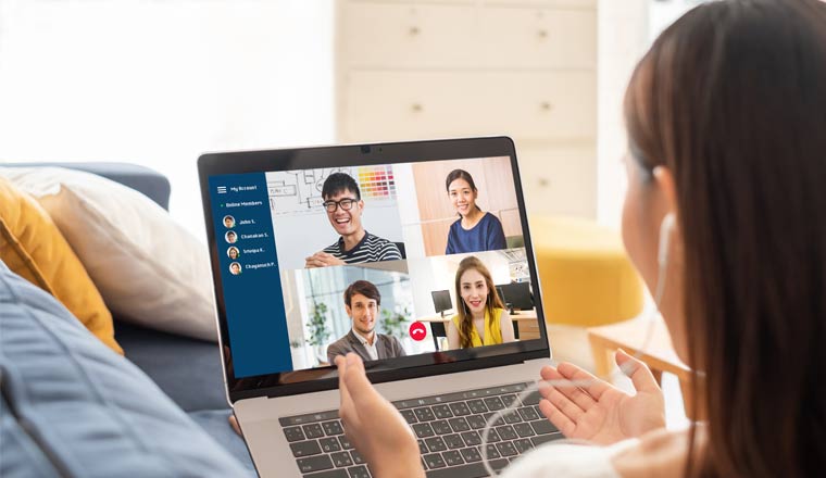 A person on a laptop having a virtual meeting with four other people