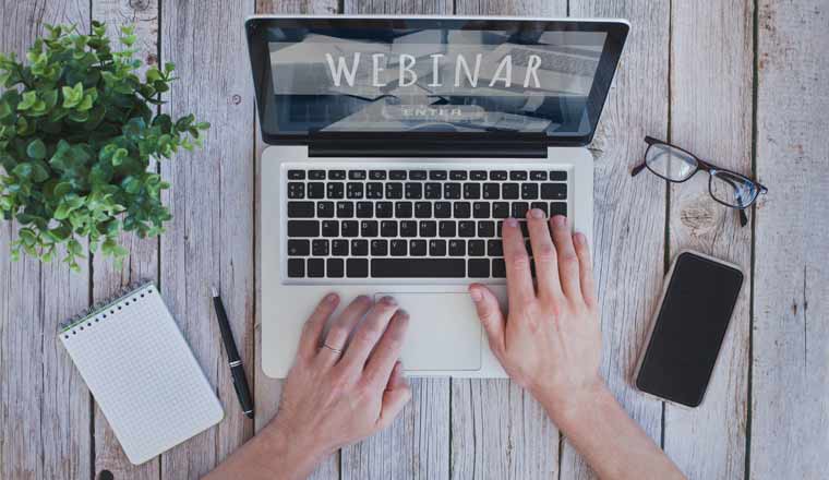 A picture of a laptop with webinar recording on screen