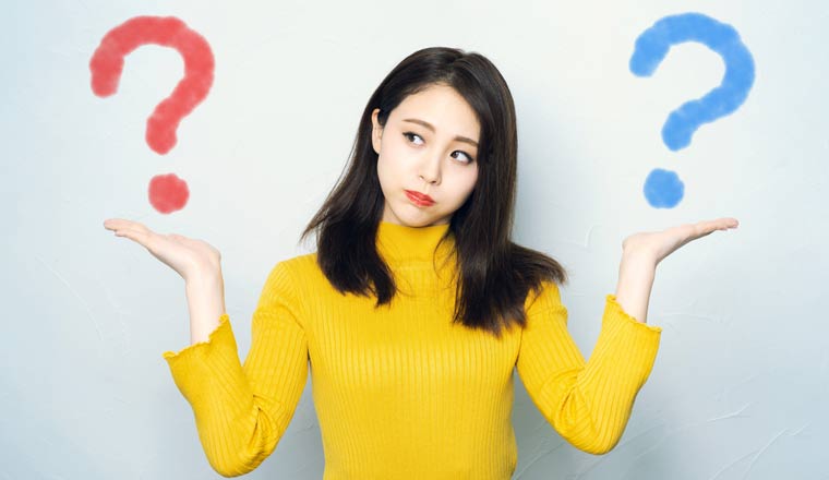 A person with a blue and red question mark on either side floating above their hands