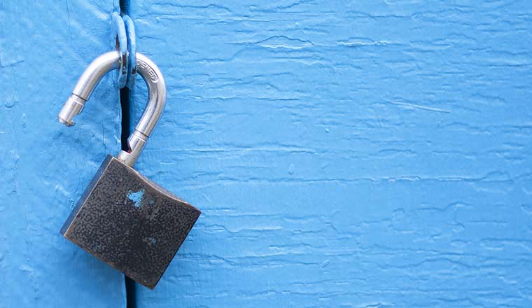 Open lock on blue door background