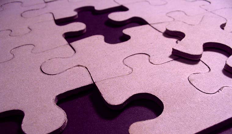 A purple puzzle with missing pieces